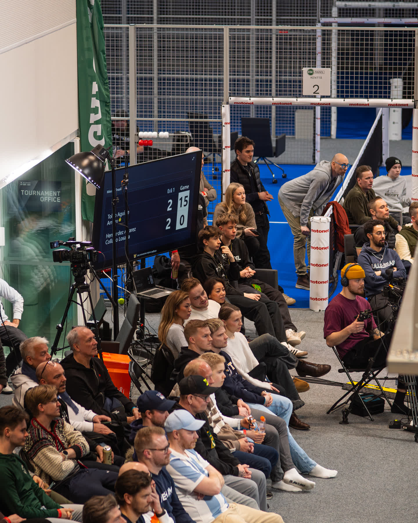 A tournament crowd watching the Padlo scoreboard on a big venue screen